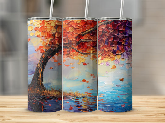 Three tumblers with colorful autumn tree artwork reflected in water.