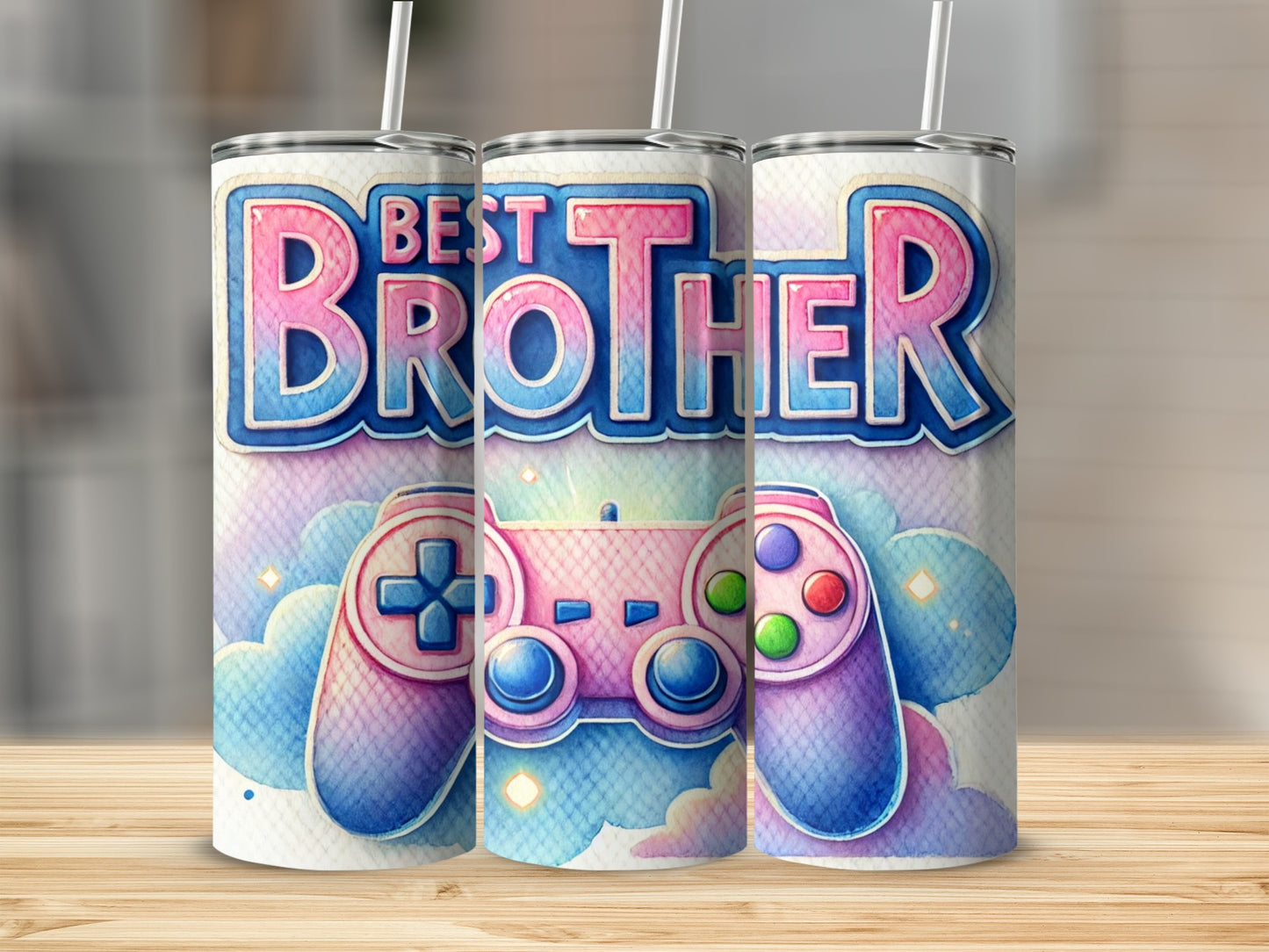 Three tumblers with "Best Brother" and game controller design on a wooden surface.