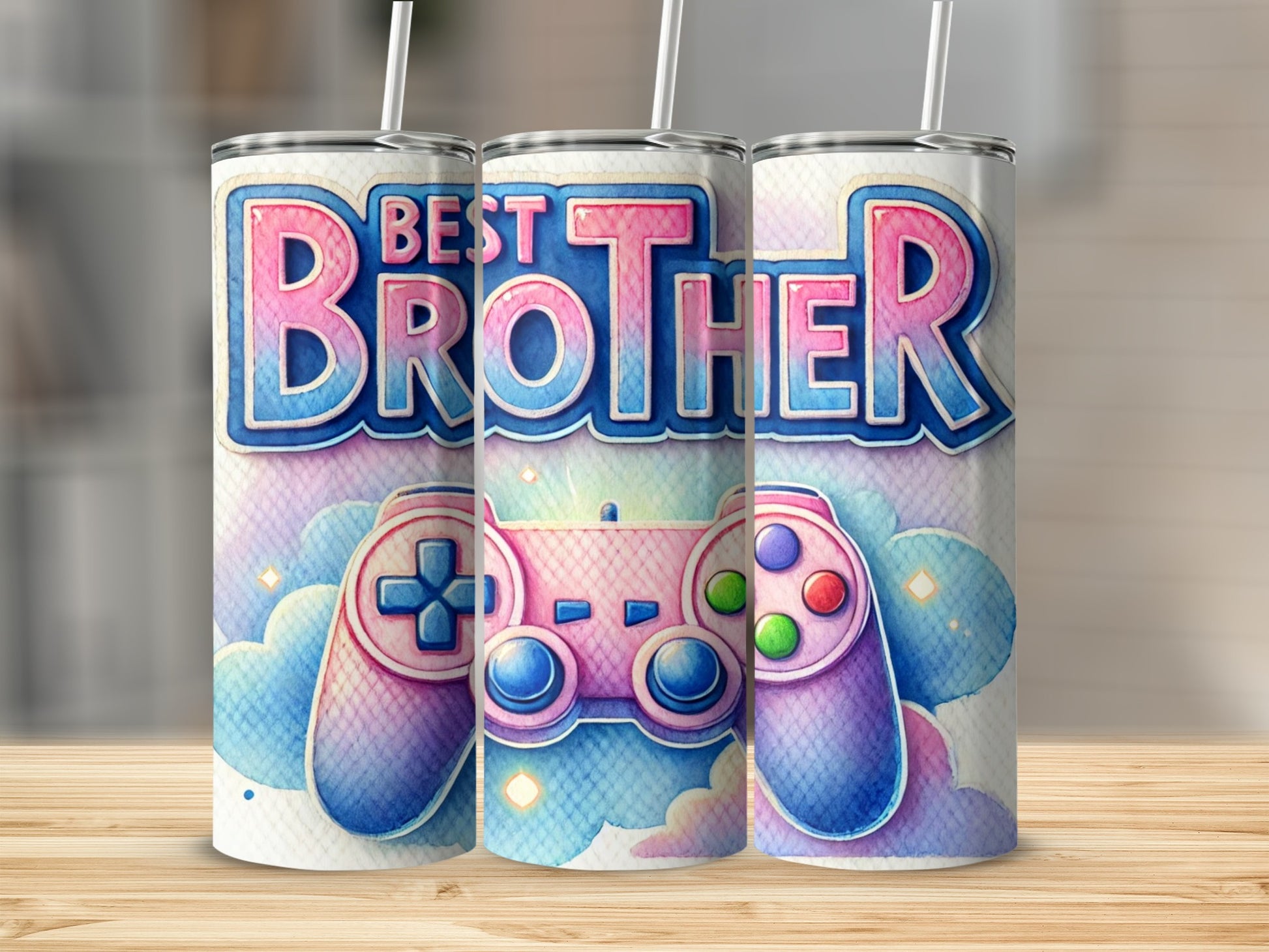 Three tumblers with "Best Brother" and game controller design on a wooden surface.