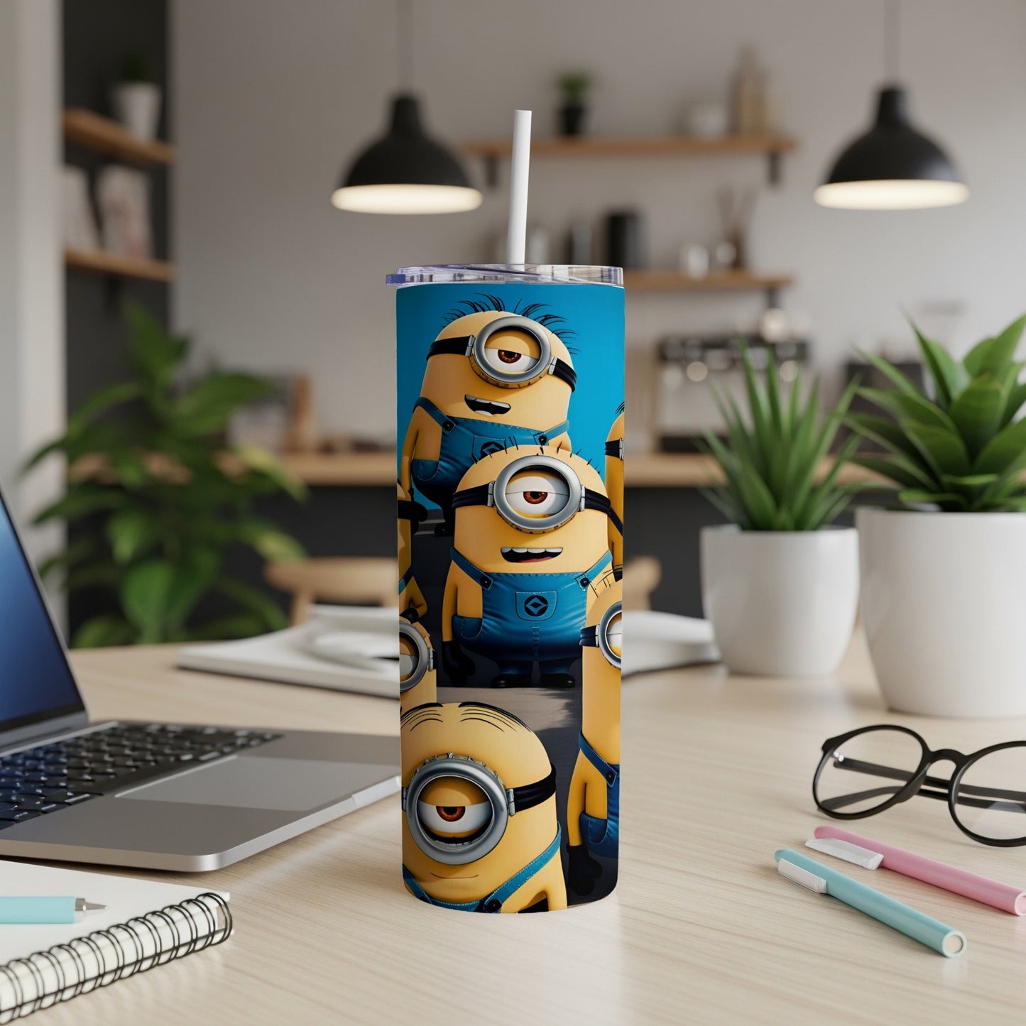 Minions scattered on a blue background on a stainless steel tumbler.