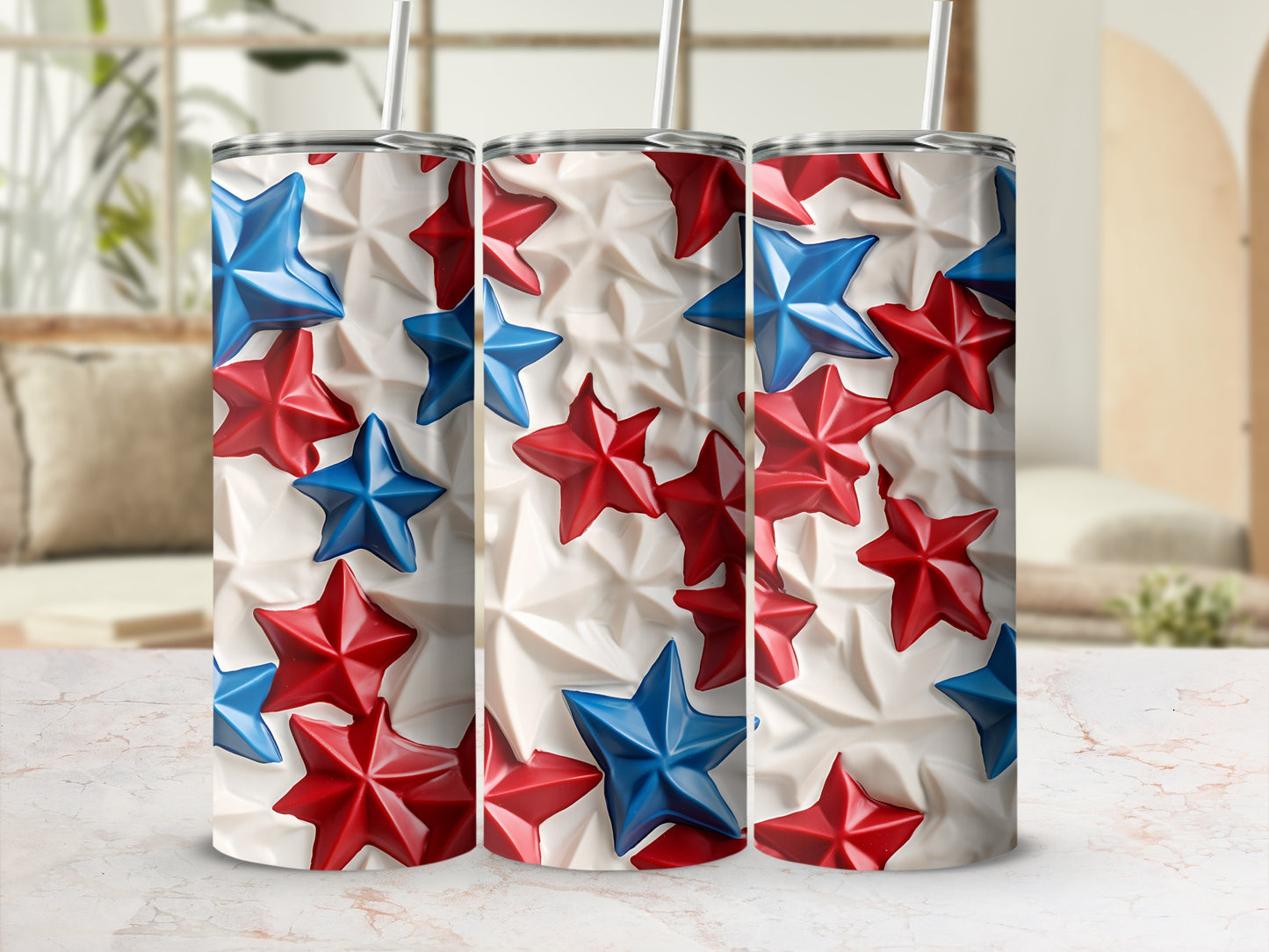 Three tumblers with a red and blue star pattern, on a marble surface.