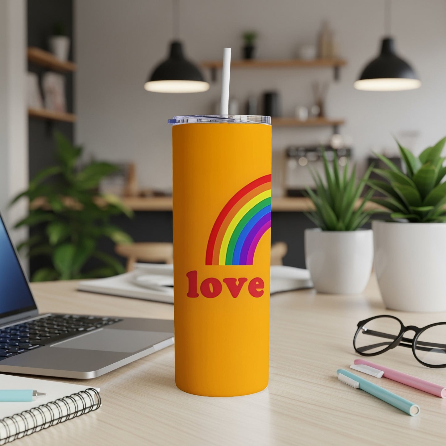 Orange tumbler with rainbow and "love" text.