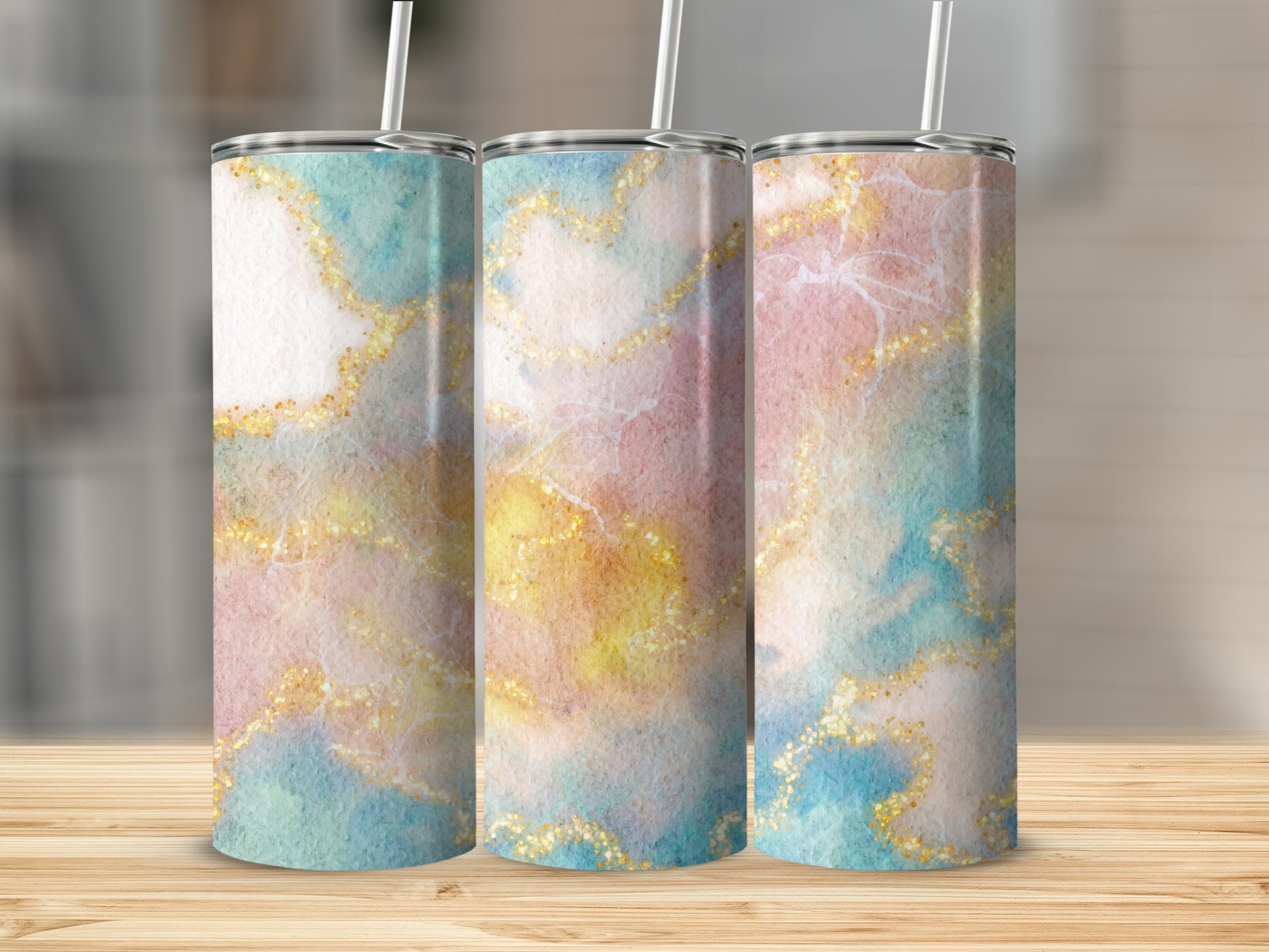 Three tumblers with a marbled watercolor and gold glitter design.