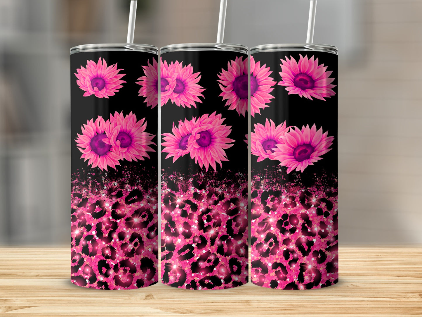 Pink sunflowers and glitter leopard print on three black tumblers.