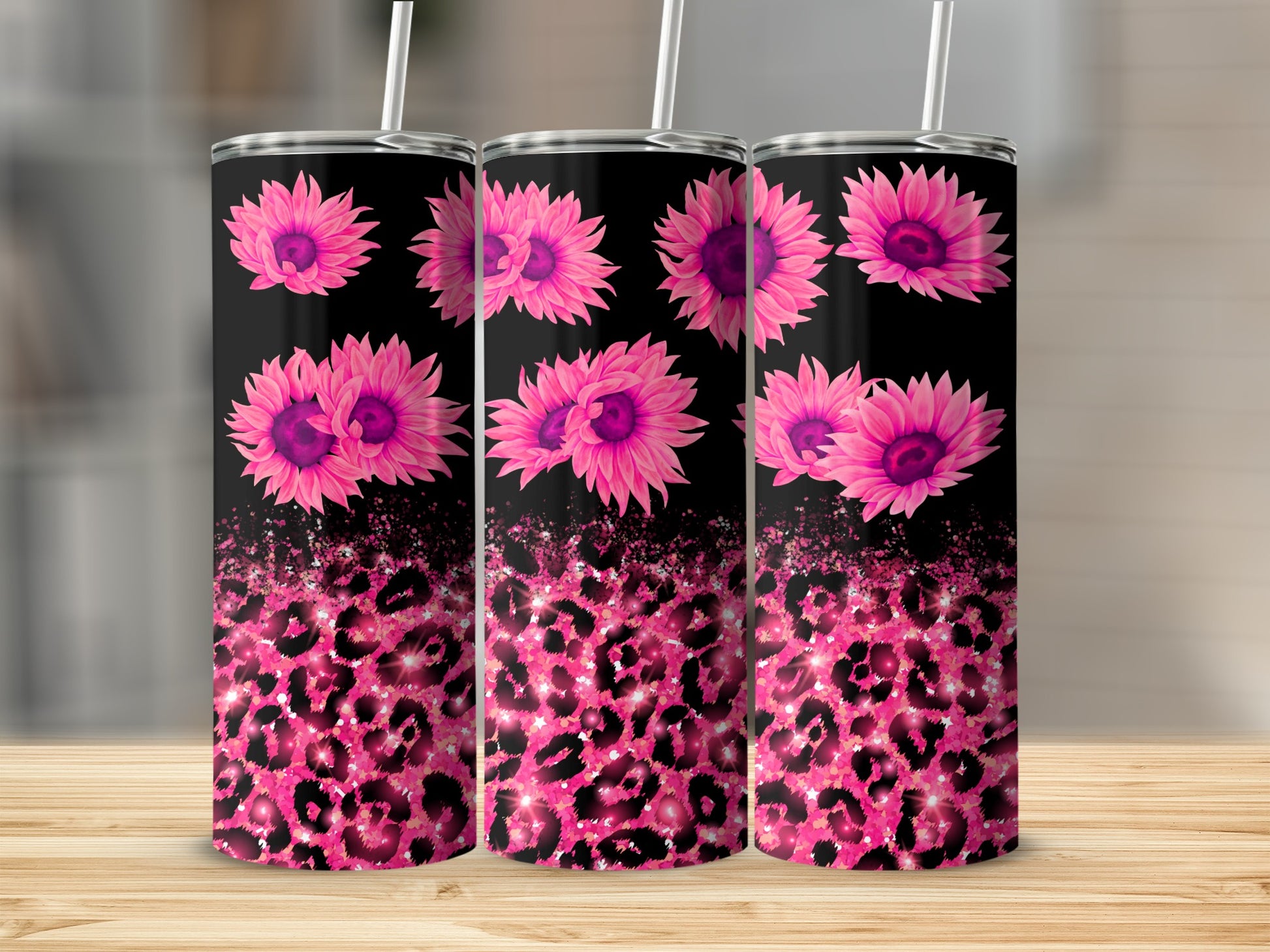 Pink sunflowers and glitter leopard print on three black tumblers.