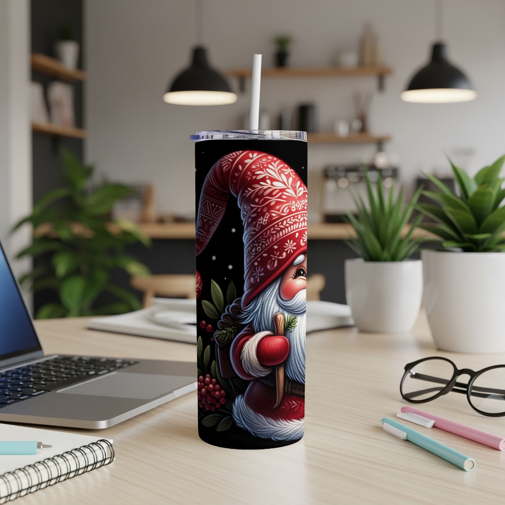 Red and white patterned Santa Claus tumbler with a straw.