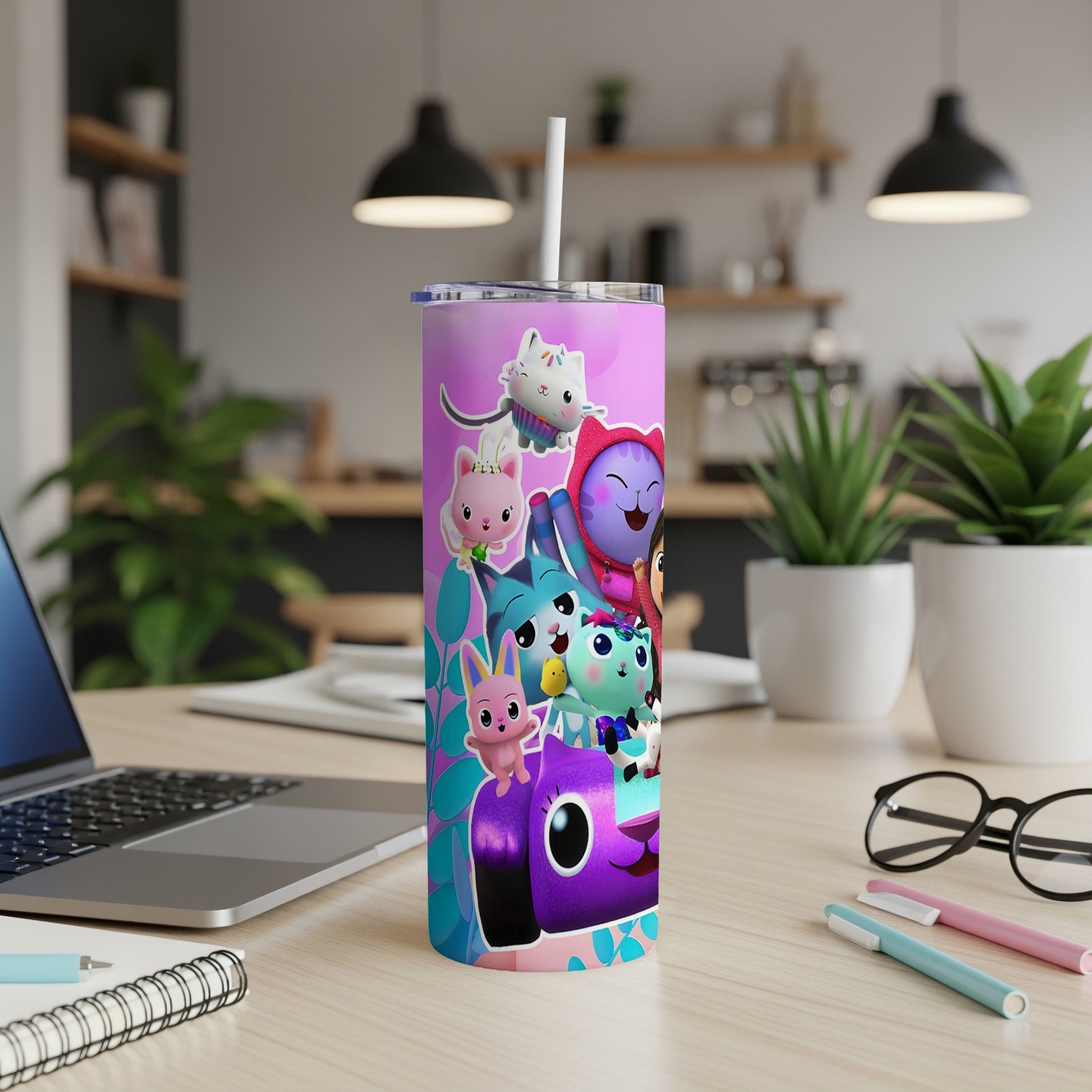 Gabby's Dollhouse characters on a purple and pink tumbler with a straw.