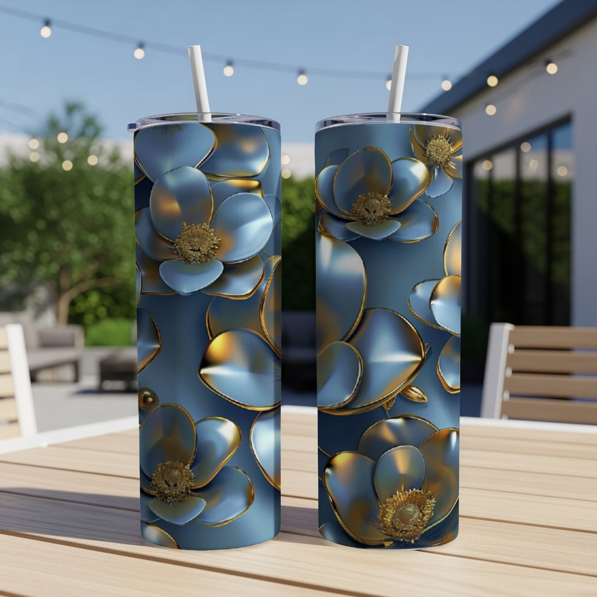 Two blue floral tumblers with gold accents on a wooden table.