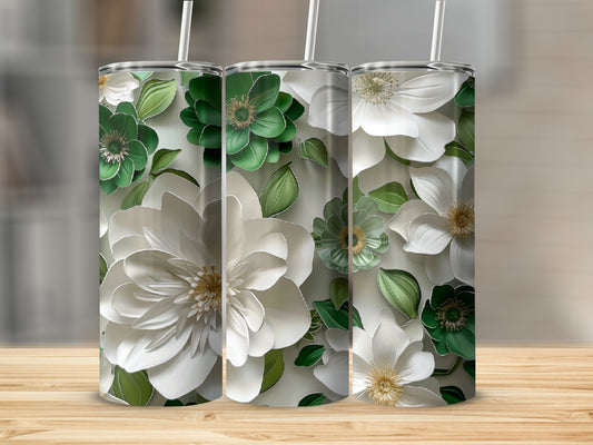Three tumblers with white and green floral designs and straws.