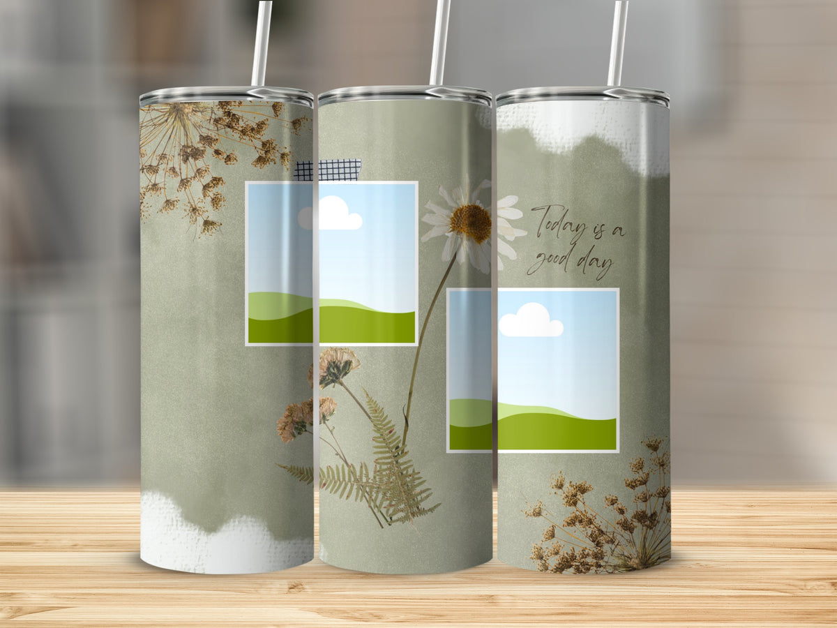 Three tumblers with dried flowers and framed landscape scenes.