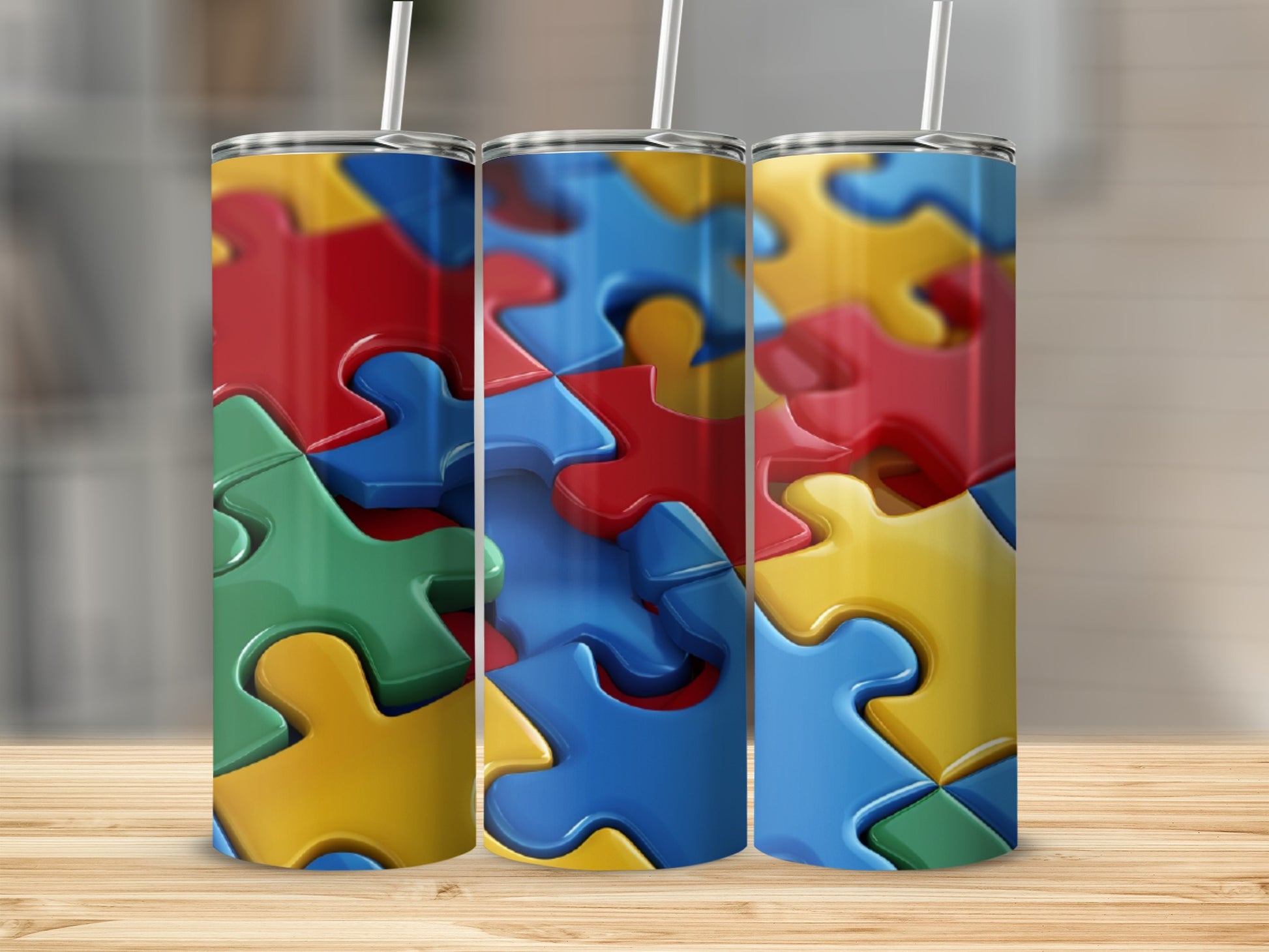 Three tumblers featuring colorful, interlocking puzzle pieces in red, blue, and yellow.