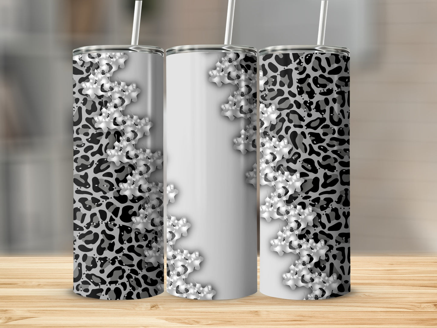 Three tumblers with leopard print and snowflake designs.