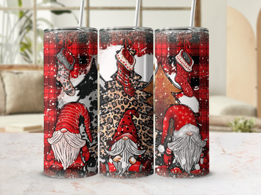 Three Santa gnome tumblers with buffalo plaid, leopard print, and Christmas tree designs.