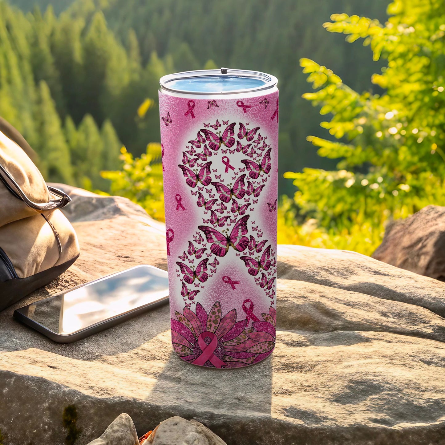 Pink butterfly and ribbon tumbler with a forest background.
