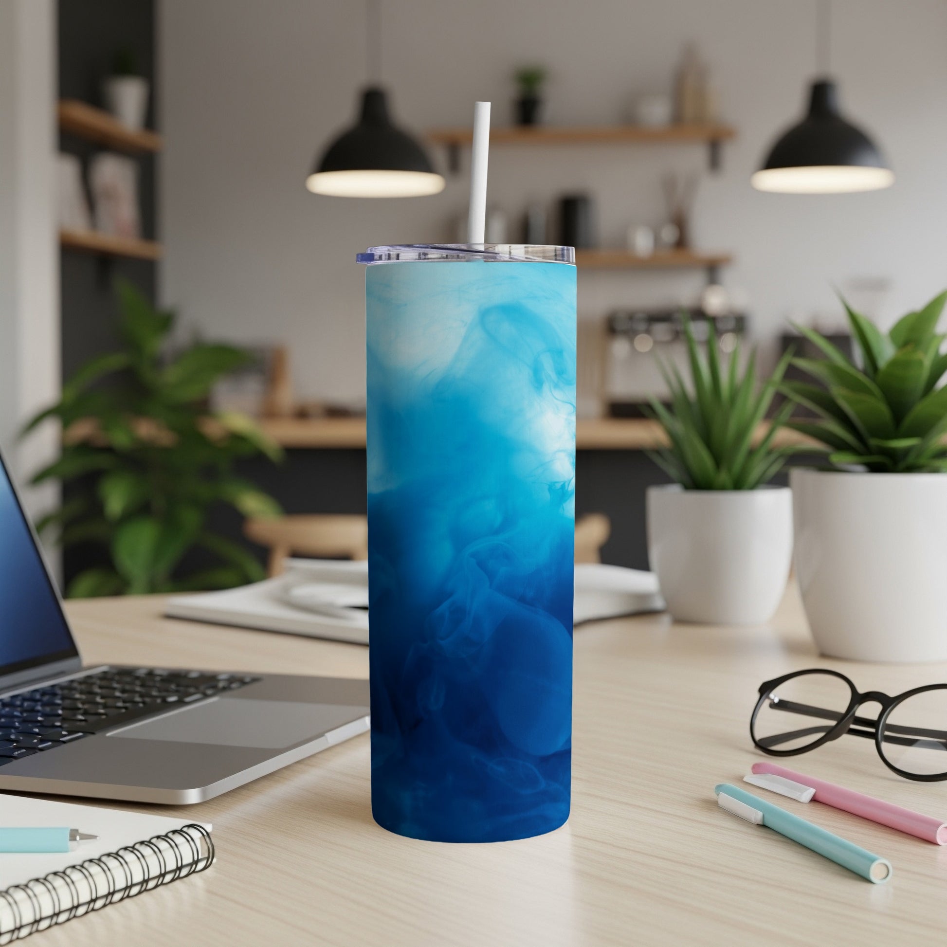 Blue and white abstract smoke pattern on a tumbler with a straw.
