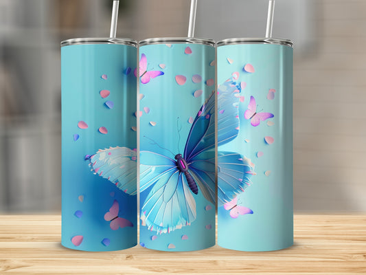 Three blue tumblers with butterflies and pink petals against a blurred background.