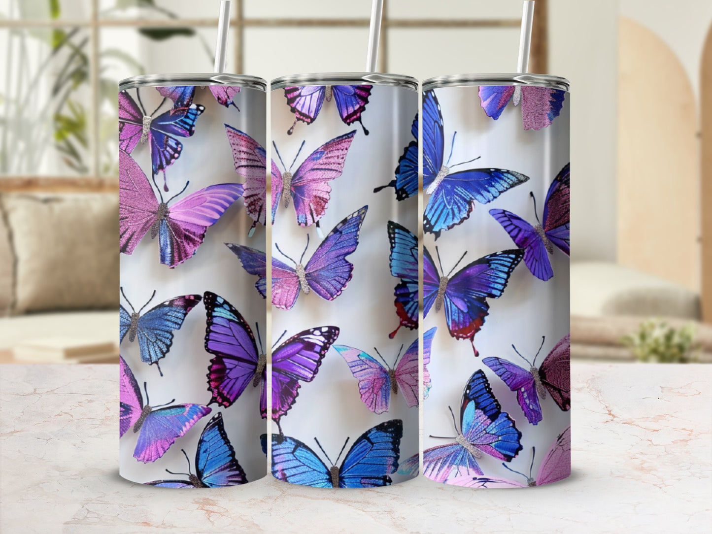 Three tumblers with a colorful butterfly design.