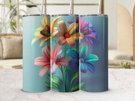 Three colorful floral tumblers with straws on a table.