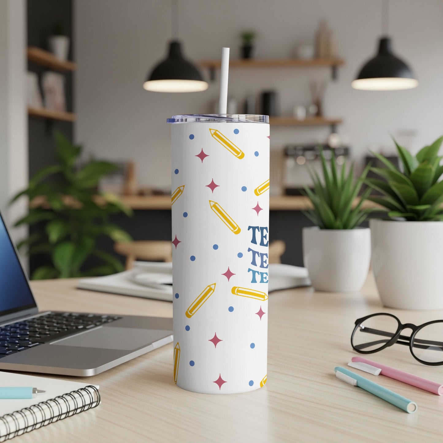White tumbler with colorful pencil and star pattern and "TEACH" text.