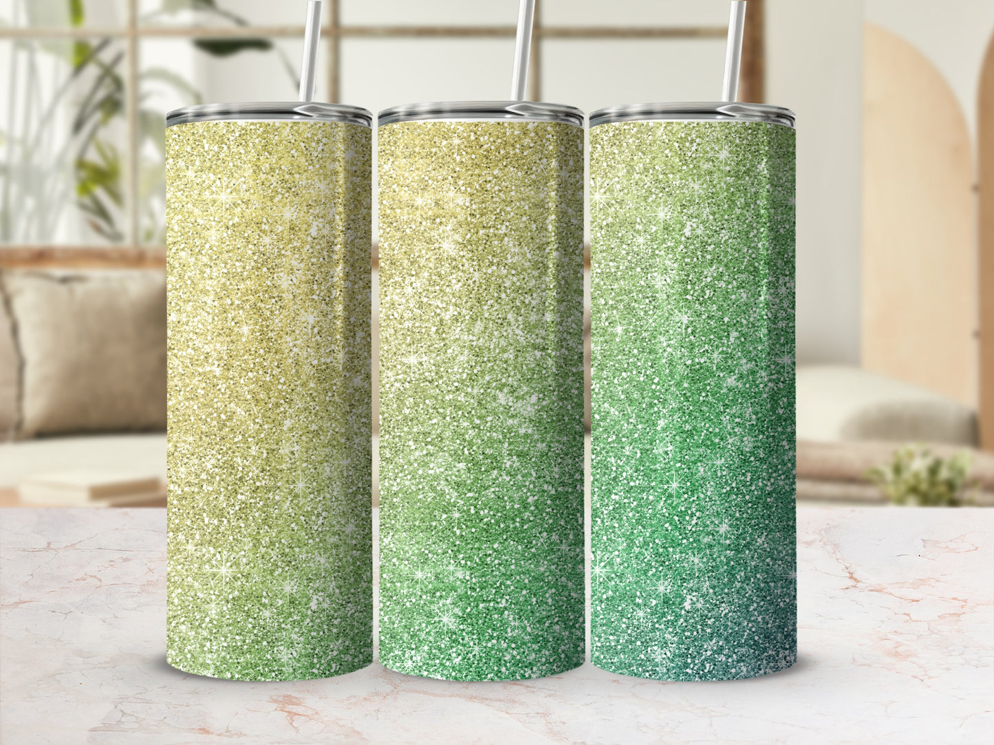 Three glitter tumblers with gradient ombre from yellow to green, featuring straws.