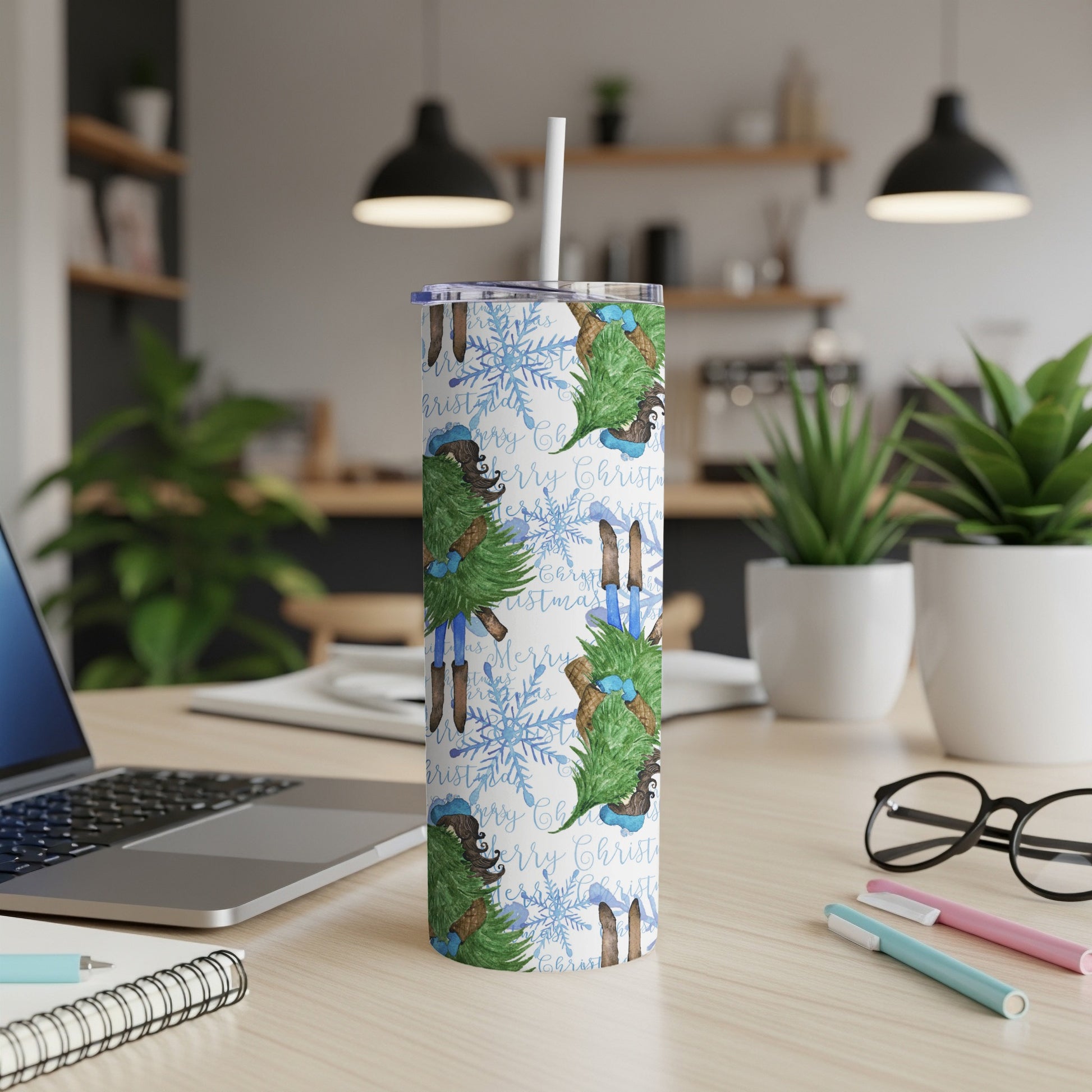 White tumbler with "Merry Christmas" text and blue snowflake pattern.