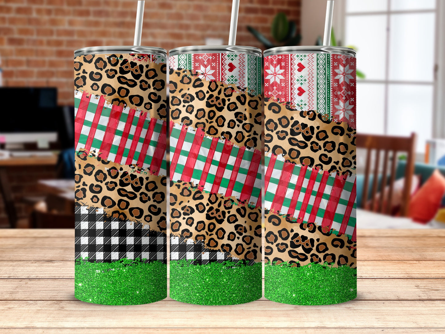Three tall tumblers with leopard print, plaid, and glitter Christmas patterns.