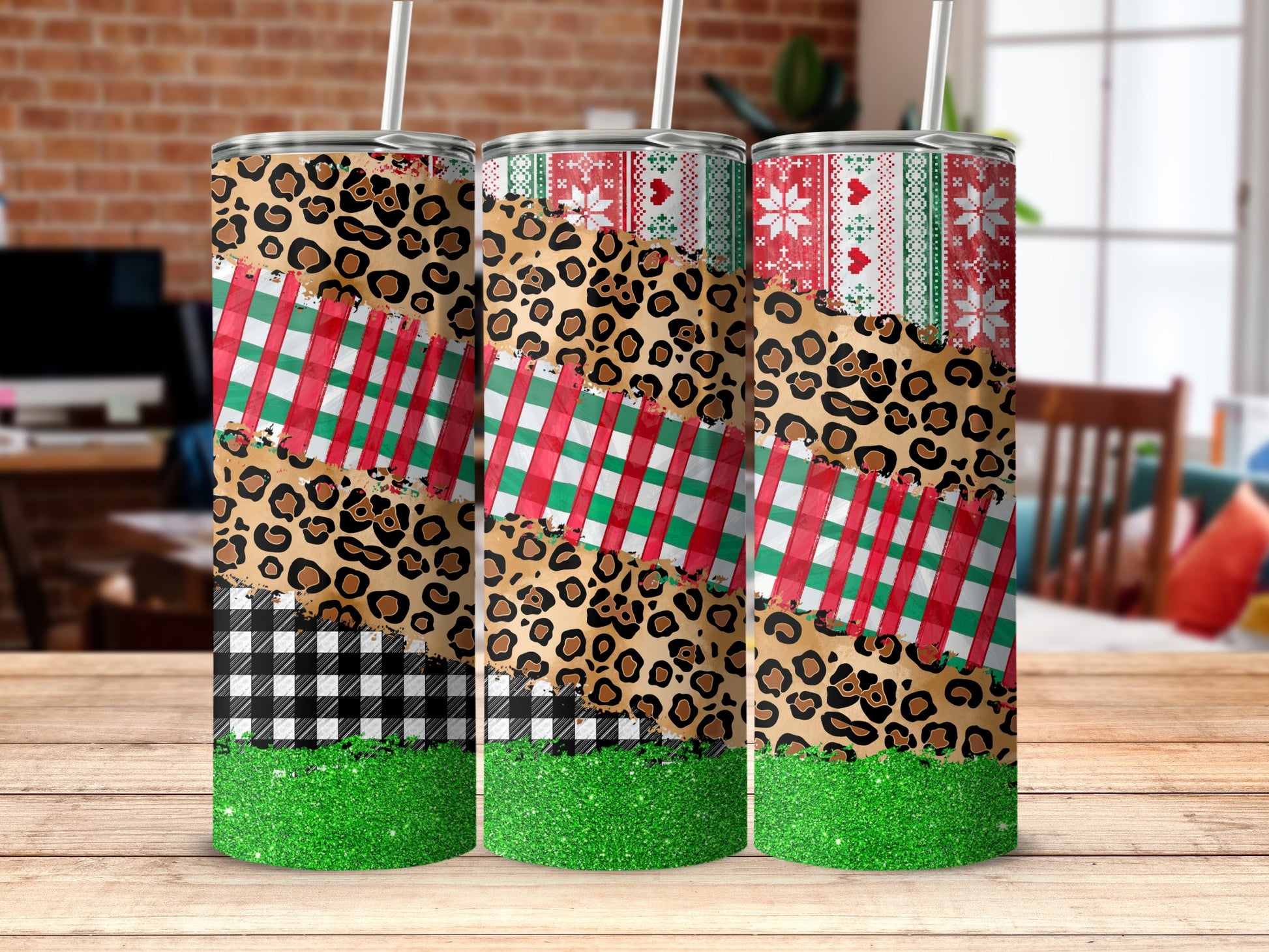 Three tall tumblers with leopard print, plaid, and glitter Christmas patterns.