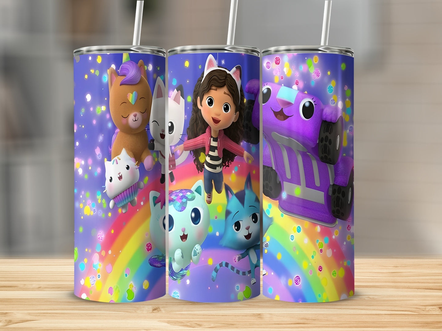 Gabby's Dollhouse characters on a rainbow and confetti tumbler with a straw.