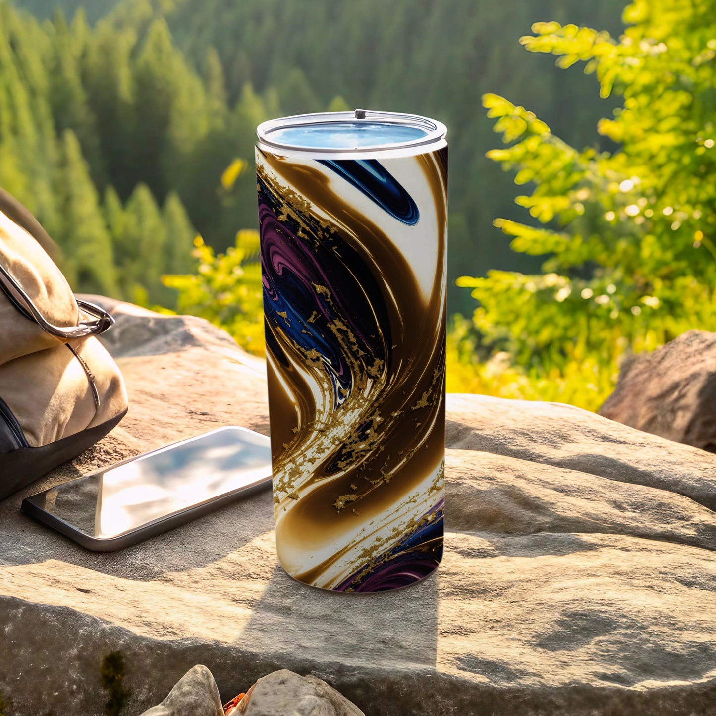 Tumbler with abstract gold, purple, and blue swirl design on a rock.