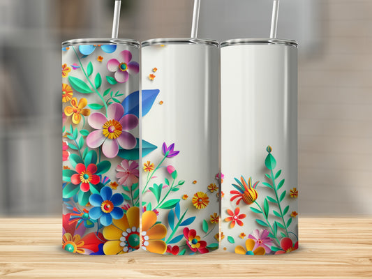 Three white tumblers with colorful floral designs and straws.