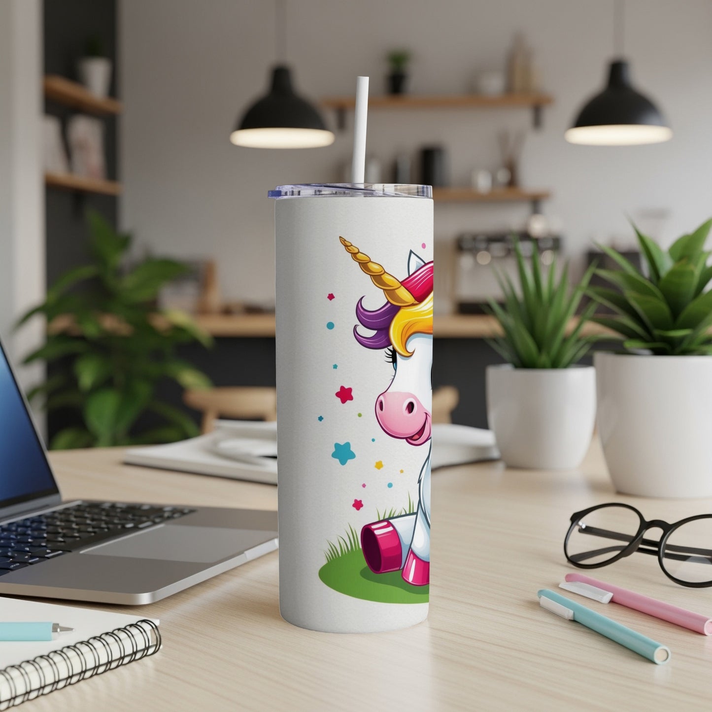 White tumbler with a cartoon unicorn and rainbow mane.