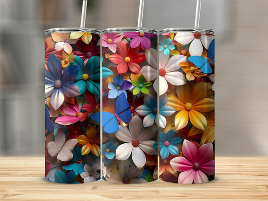 Three tumblers with vibrant floral and butterfly patterns.