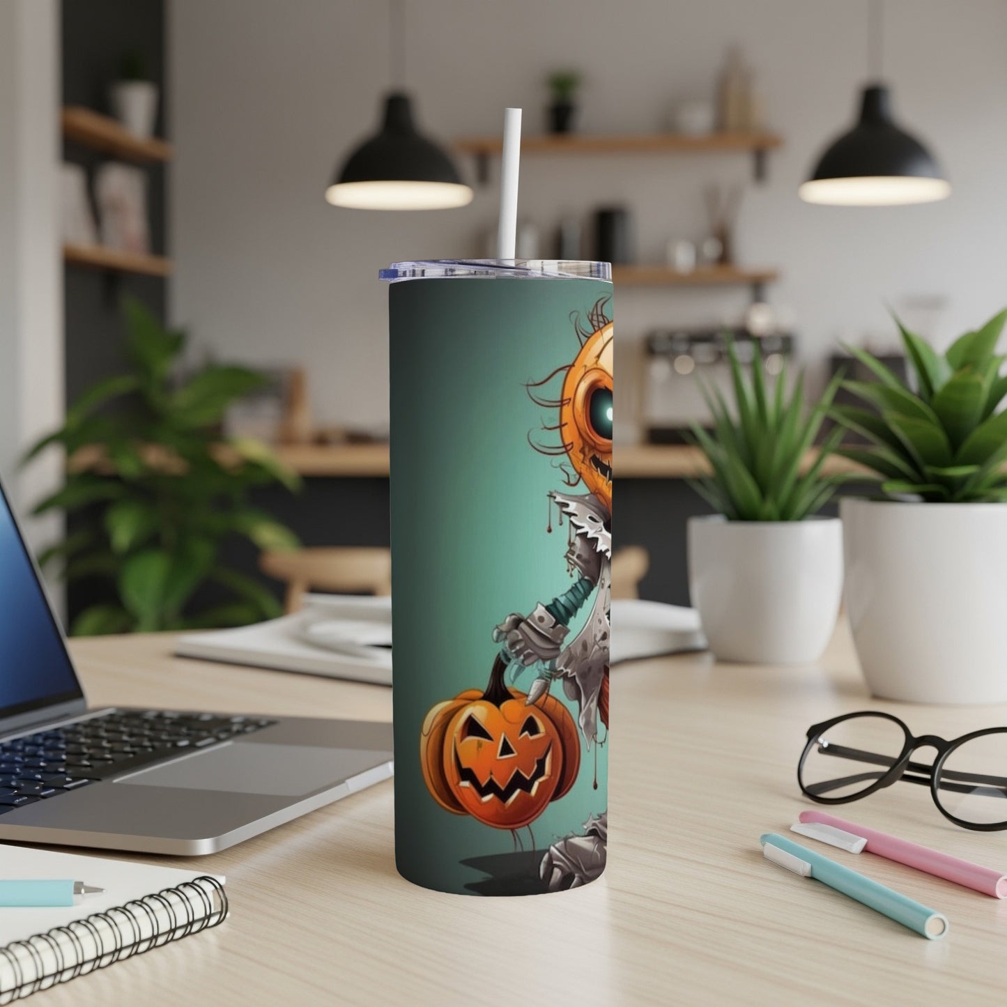 Tall tumbler with a cartoon pumpkin character holding a pumpkin on a teal background.