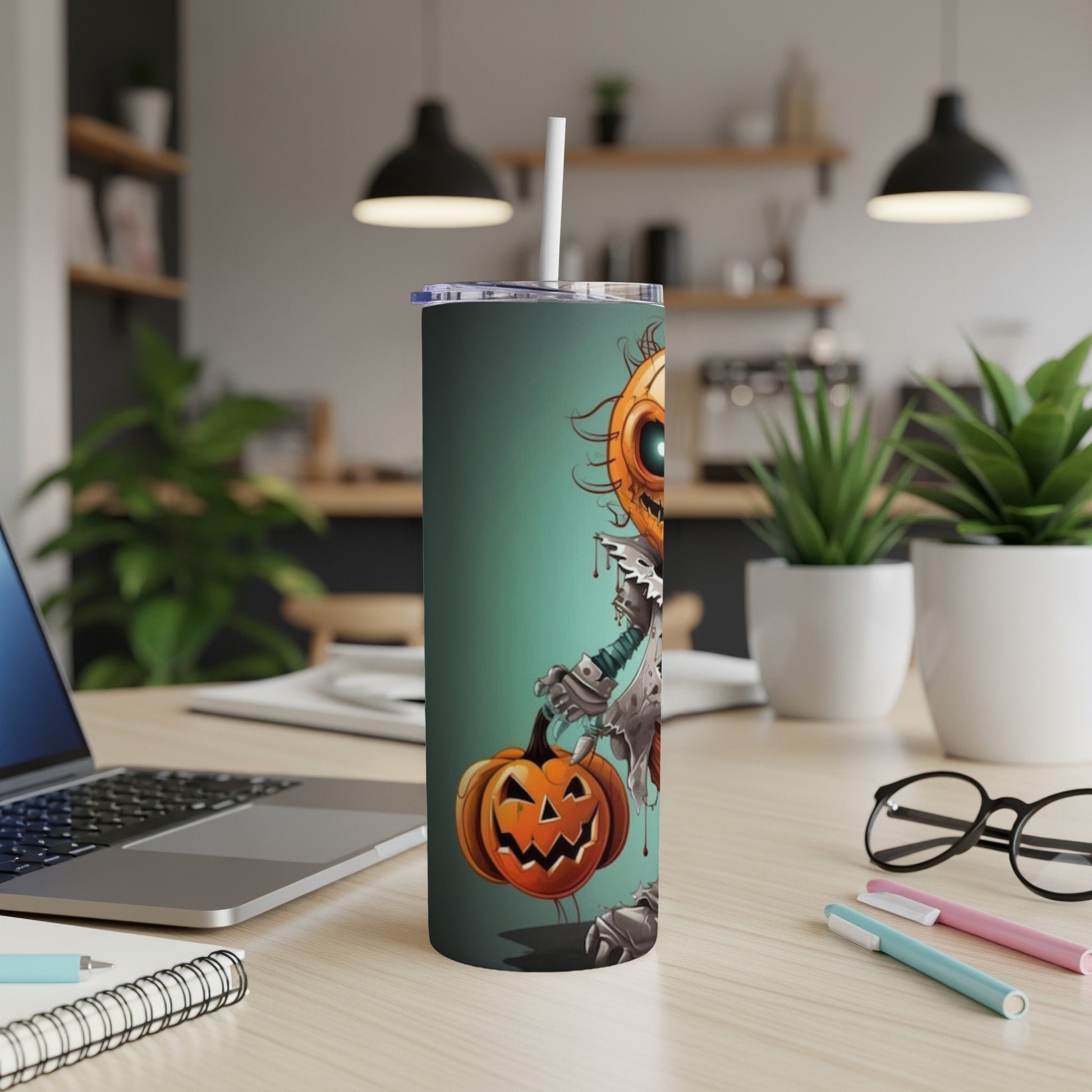 Tall tumbler with a cartoon pumpkin character holding a pumpkin on a teal background.