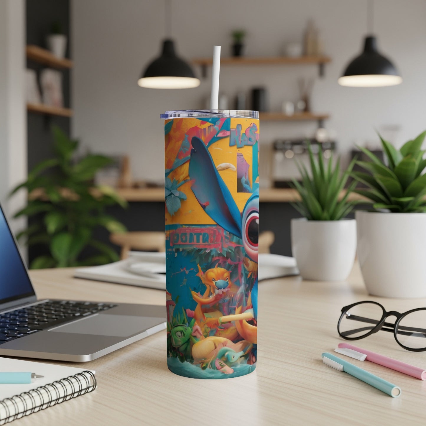 Stitch character on a colorful tumbler with straw, on a desk.
