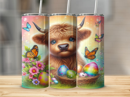 Highland cow with colorful Easter eggs and butterflies on a tumbler.