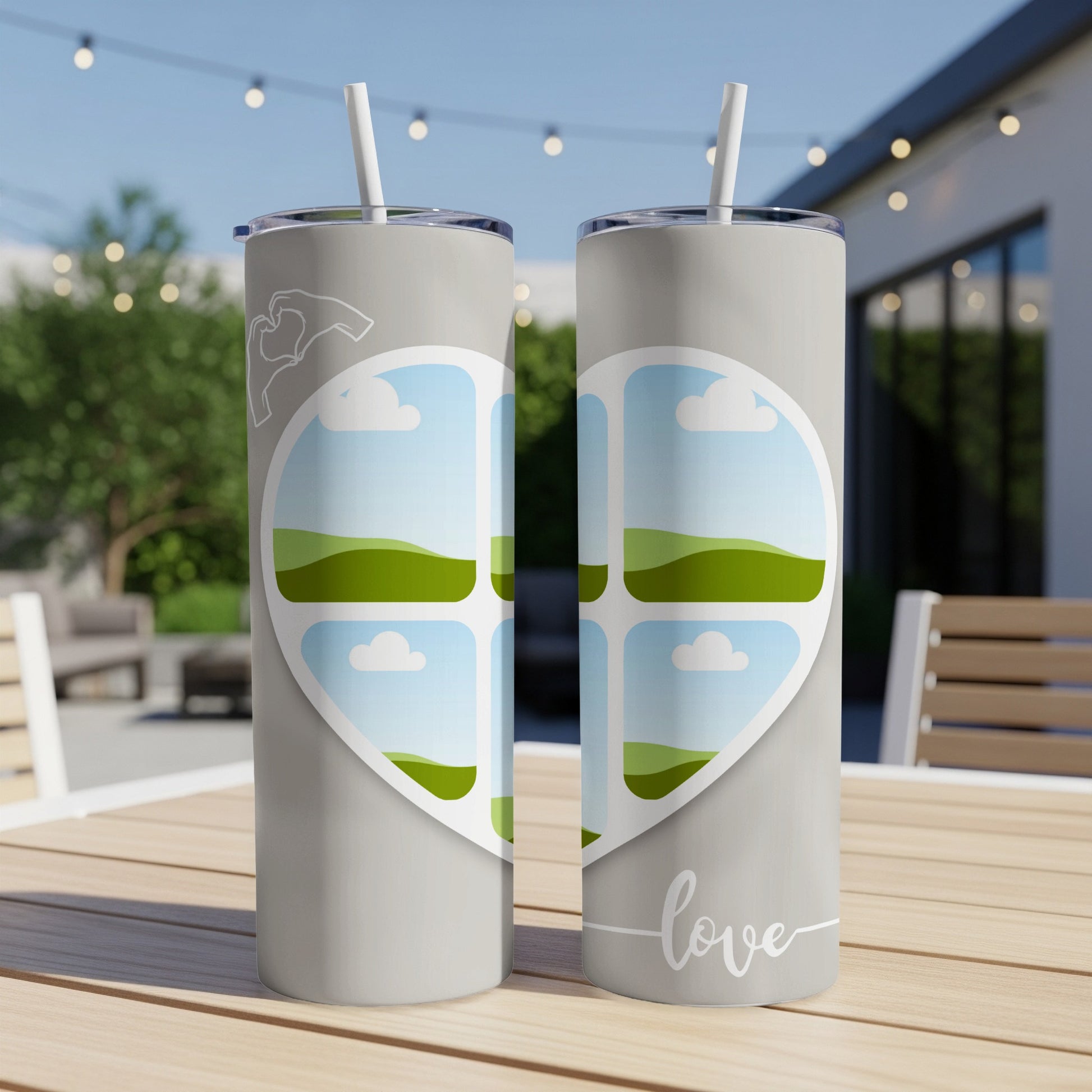 Two grey tumblers with a heart design showcasing landscape photos and the word "love".