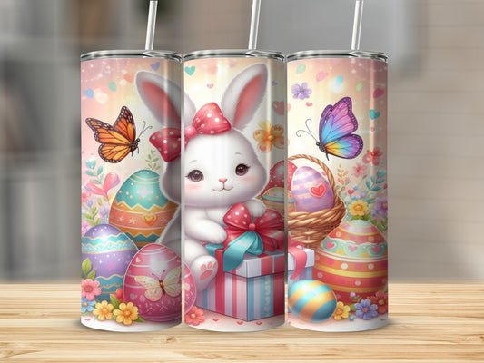 Easter bunny with colorful eggs and butterflies on a patterned tumbler.