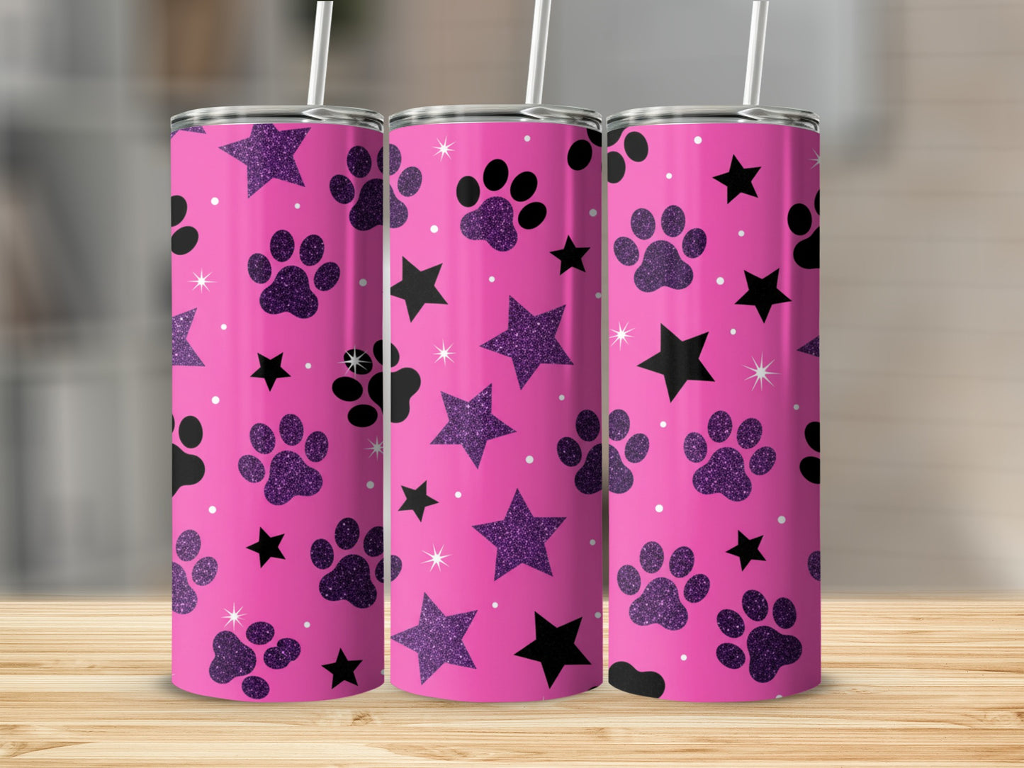 Pink tumbler with black paw prints and sparkling stars.