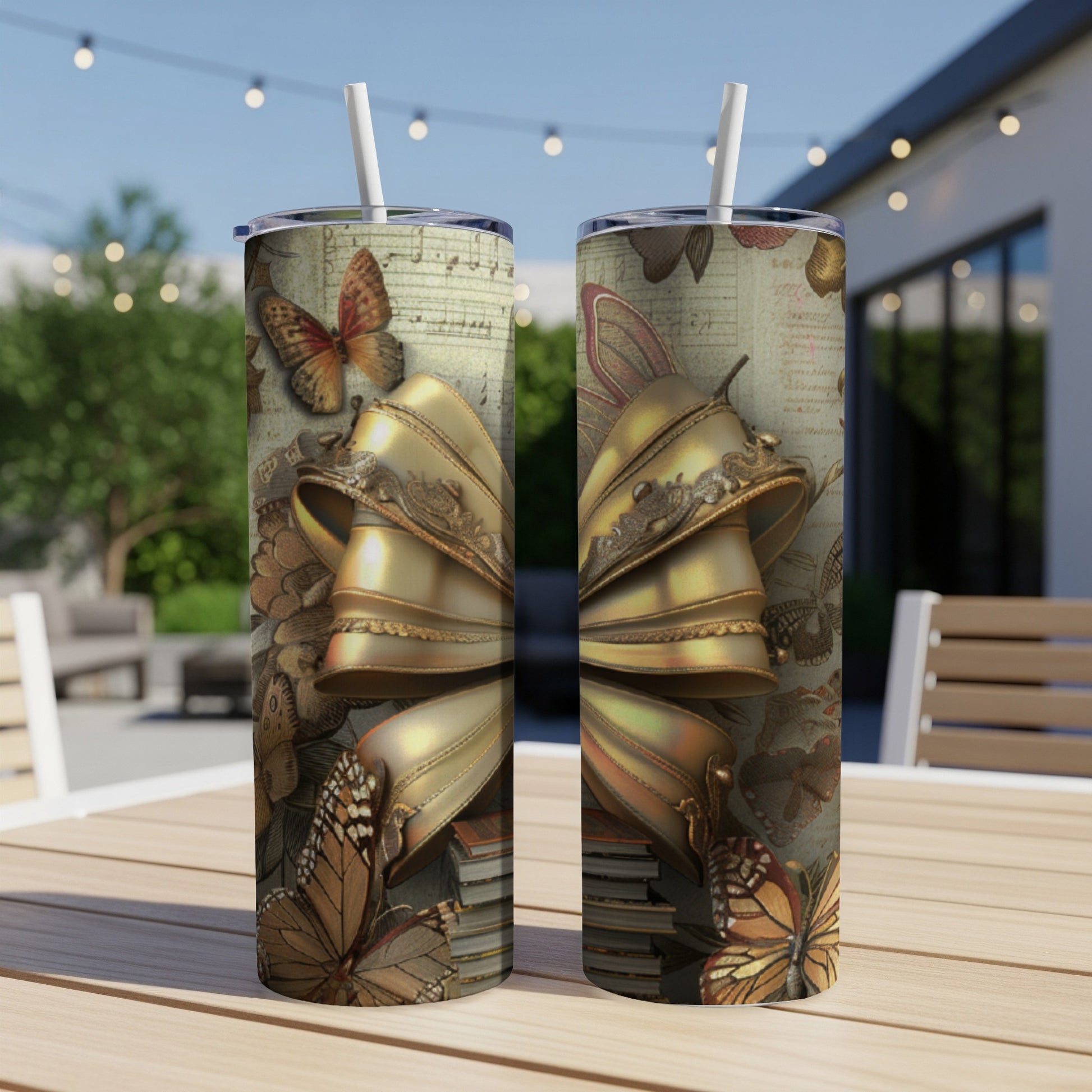 Gold bow with butterflies and musical notes on a tumbler.