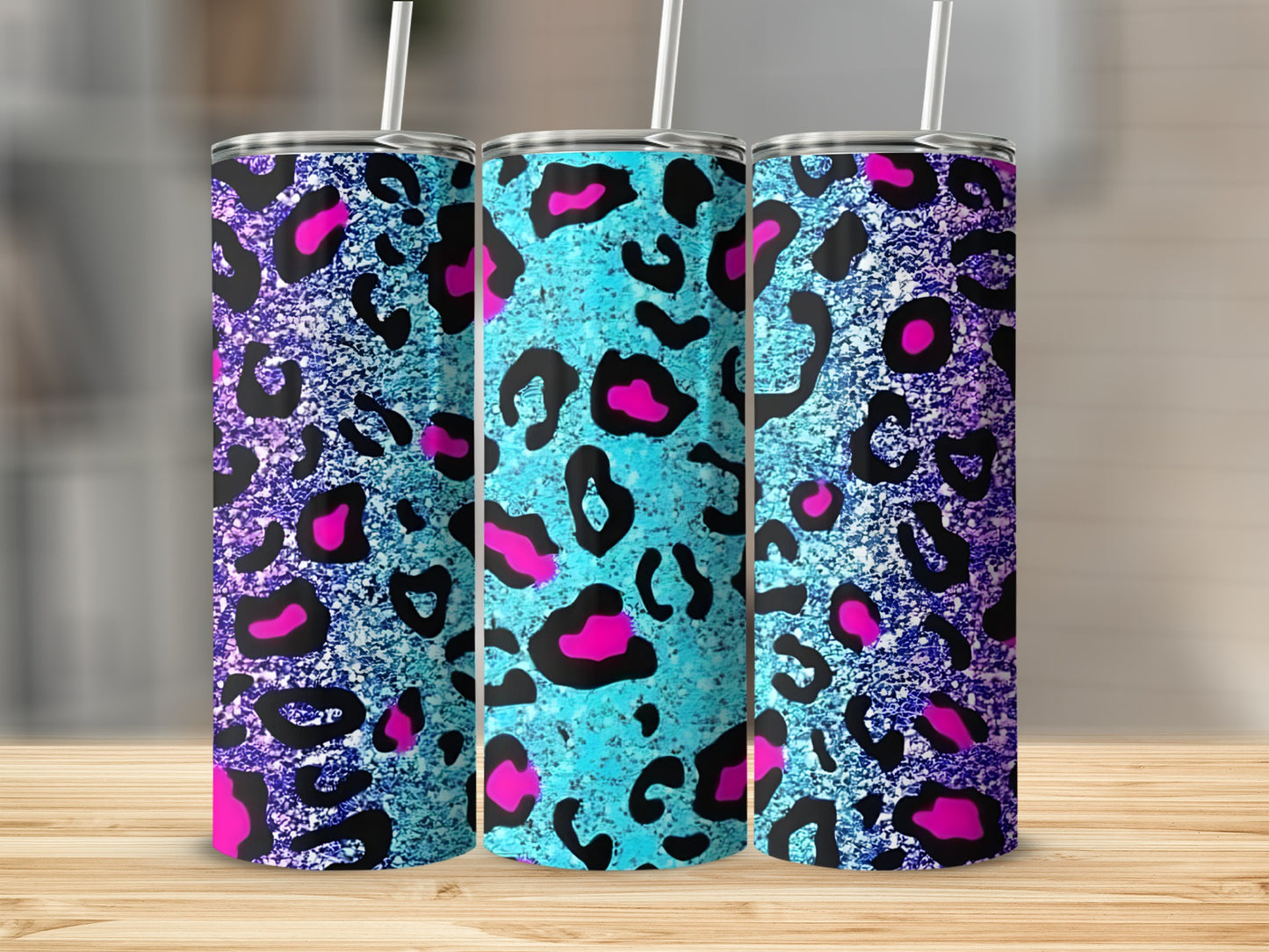 Three tumblers with teal and purple leopard print and pink accents.