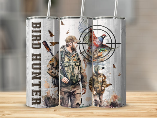 Hunting scene with father and son, pheasants, and target on a tumbler.