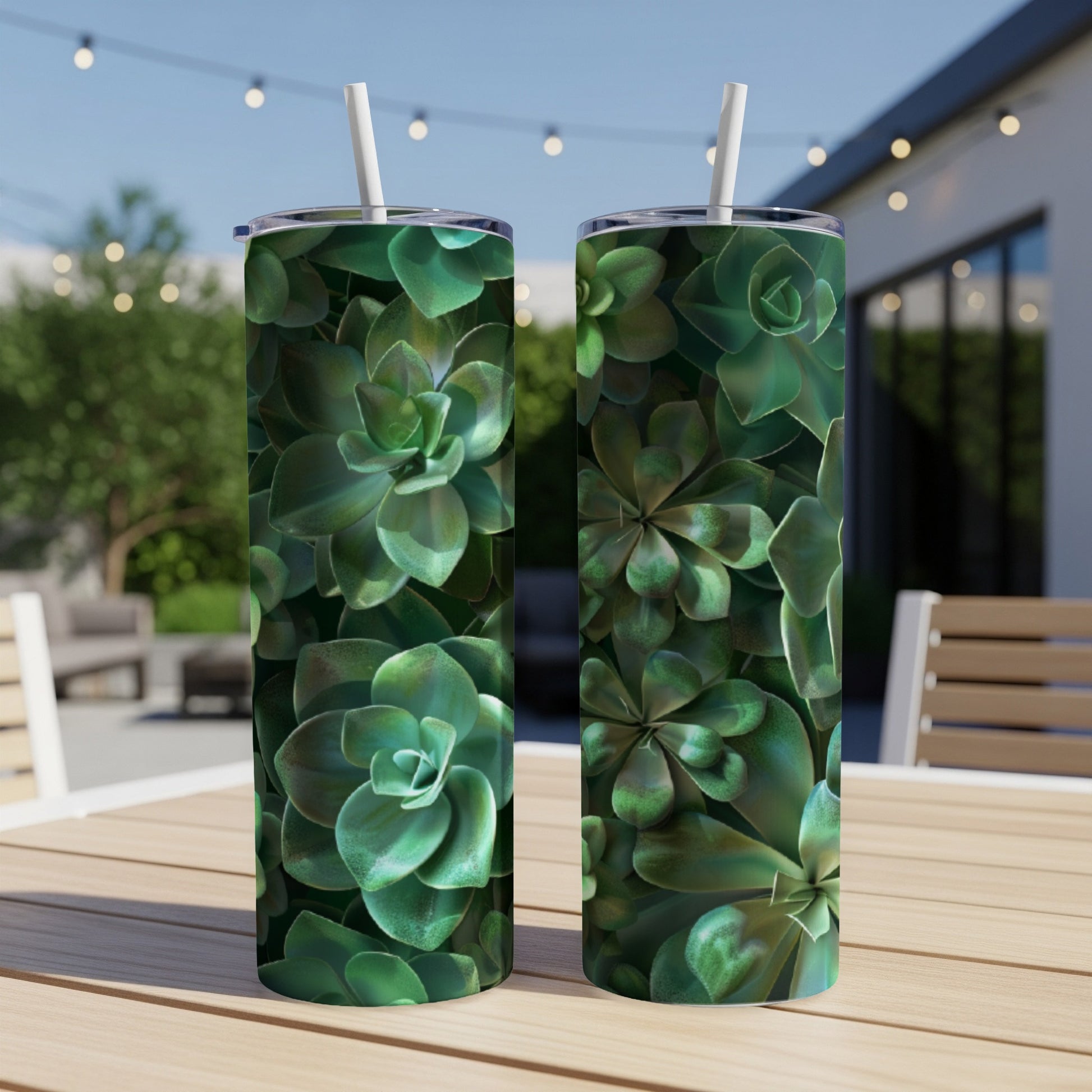 Two tumblers with green succulent pattern on an outdoor table.