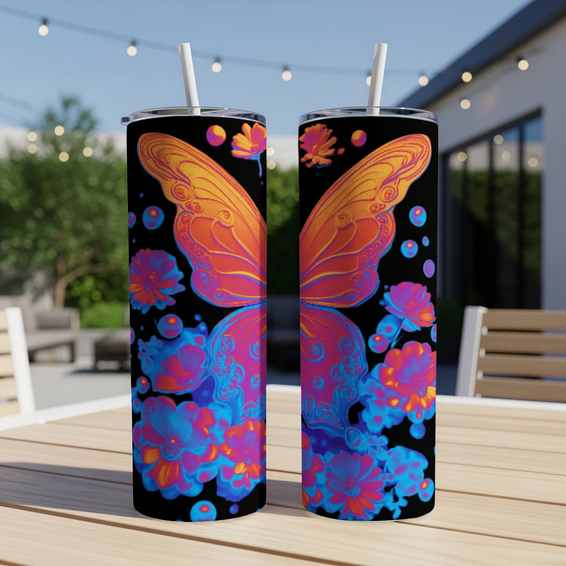 Two tumblers with a colorful butterfly and floral design on a dark background.