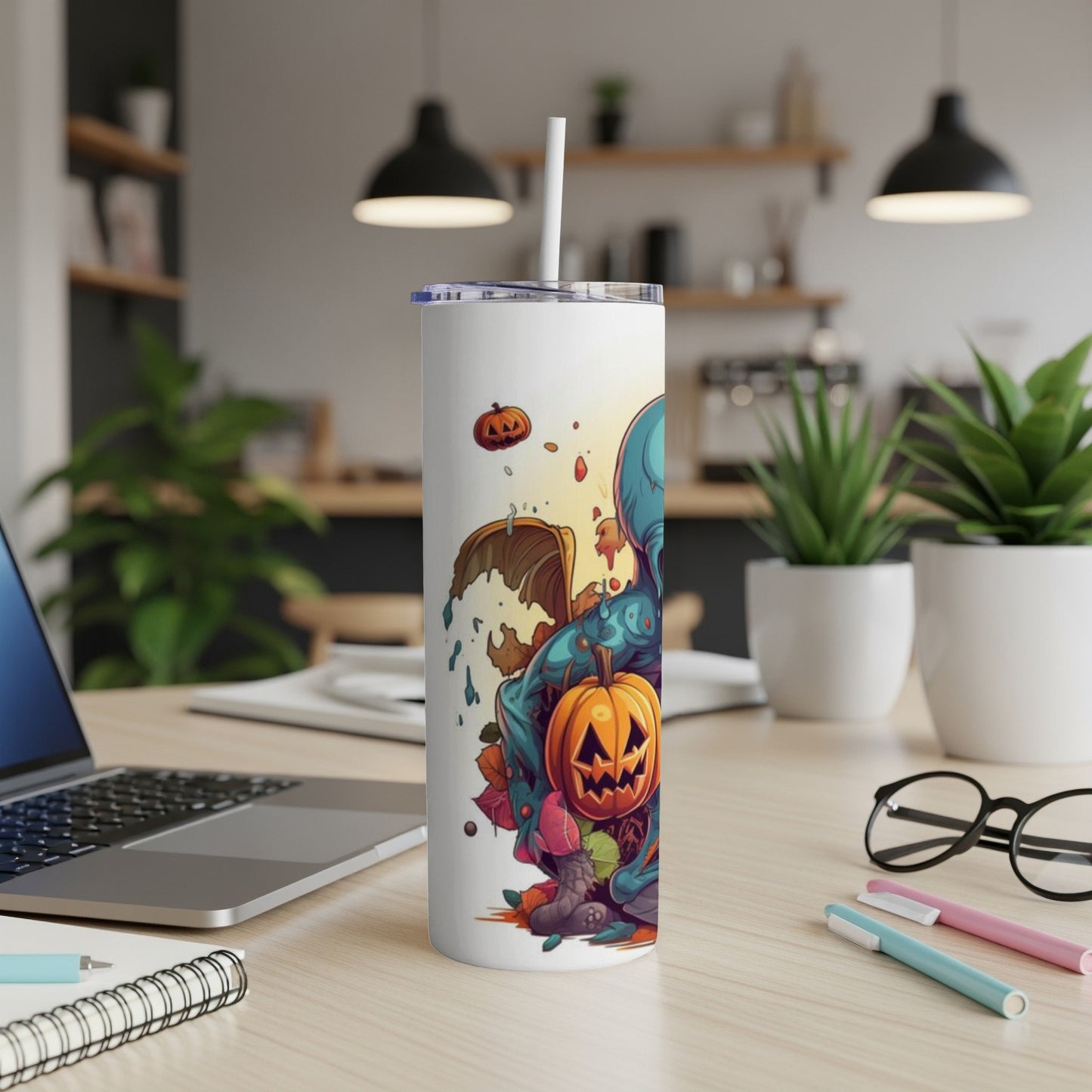 White tumbler with Halloween creature, pumpkins, and autumn leaves graphic.