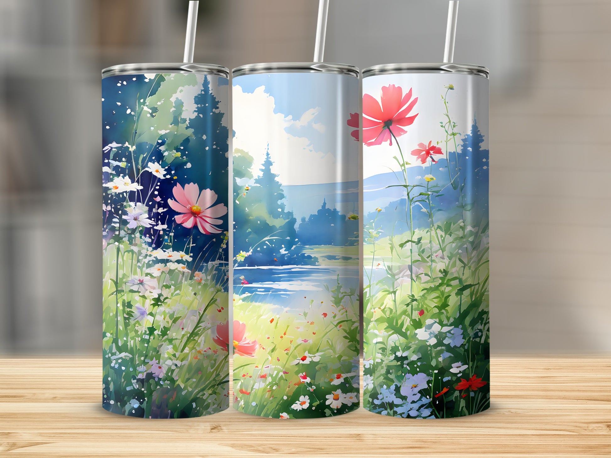 Three tumblers featuring a watercolor landscape with flowers and trees.
