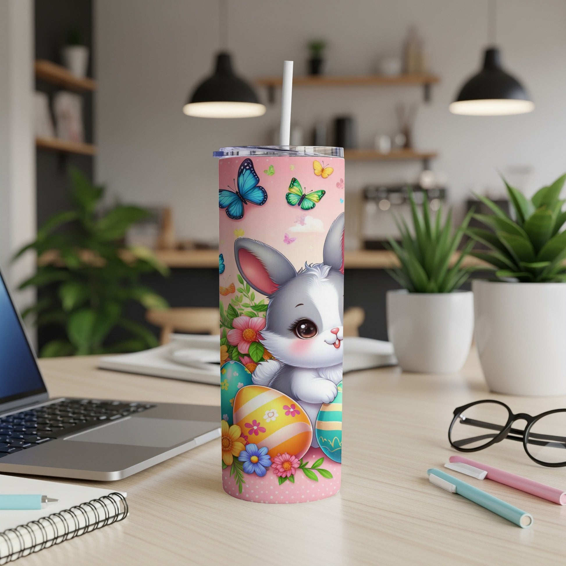 Pink tumbler with cartoon bunny, Easter eggs, and butterflies.
