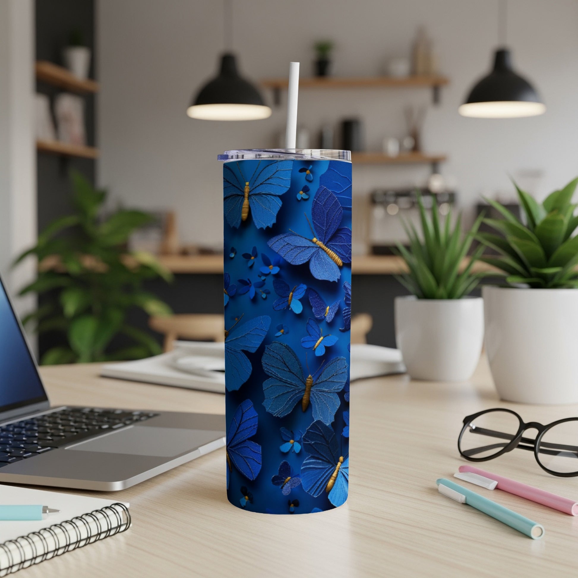 Blue butterfly pattern on a tall tumbler with a straw.