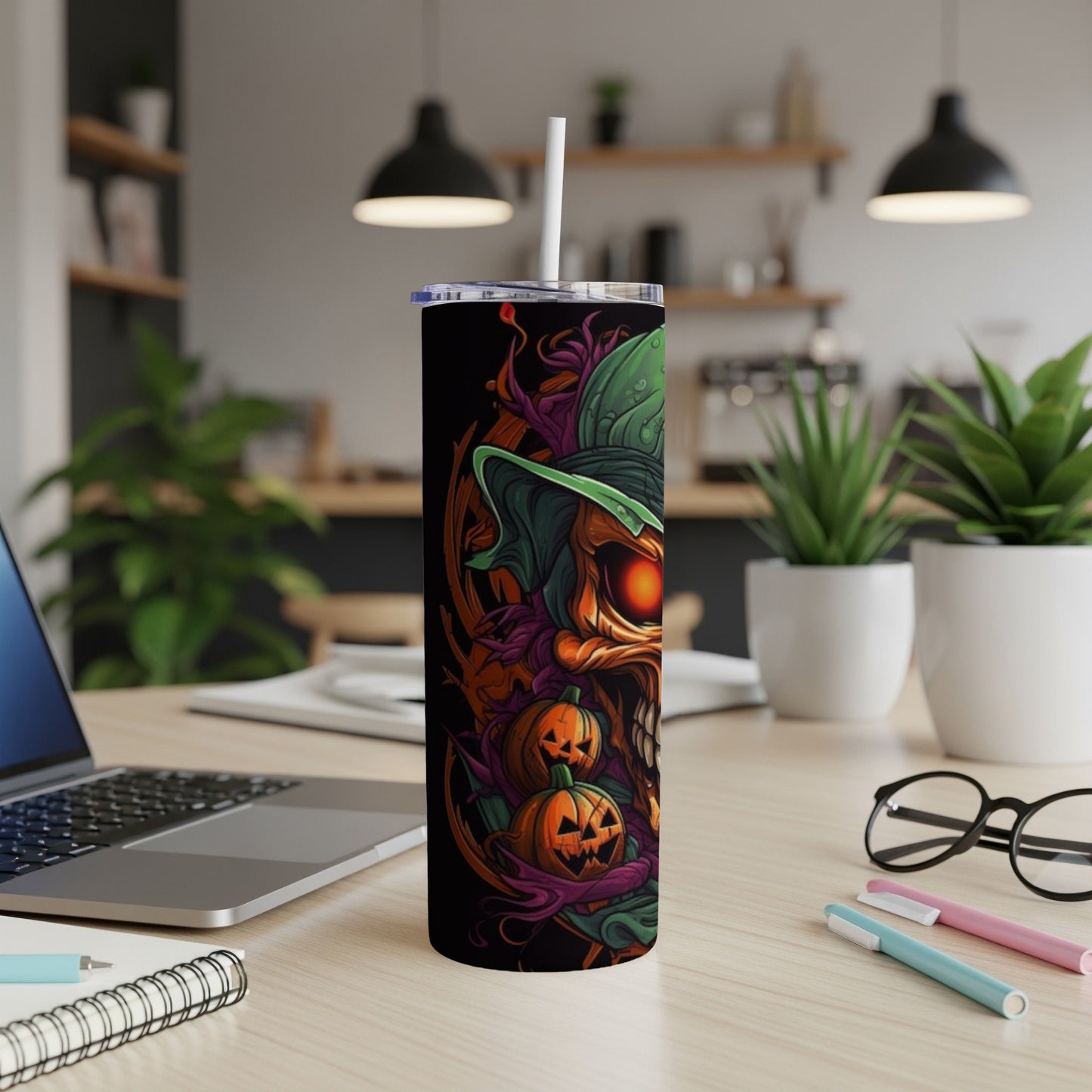 Black tumbler with Halloween-themed art featuring a skull, pumpkins, and a witch hat.