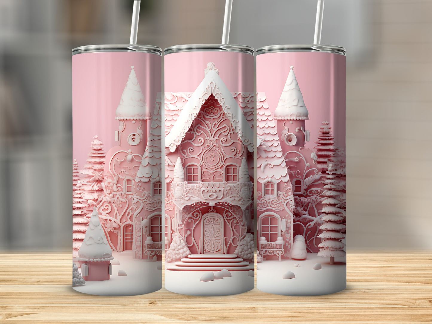Pink gingerbread house design on three tumblers with white lids and straws.